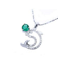 14K white gold dolphin pendant with a round deep green emerald and sparkling accents.