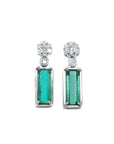 14K white gold dangling earrings with rectangular emeralds and diamond clusters.