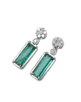 14K white gold dangling earrings with rectangular emeralds and diamond flower clusters.