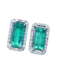 front side of a pair of emerald earrings with halo diamond white gold, top face stone's view