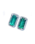 Sparkling rectangular emerald-cut stud earrings with diamond halos in 18K gold.