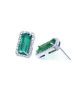 18K white gold emerald-cut stud earrings with vibrant green emeralds and diamond halos.