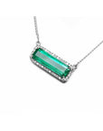 18K white gold necklace with a rectangular Colombian emerald and diamond halo, East-West design.