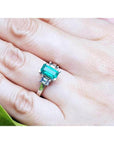 Colombian emerald engagement ring with a 1.09 ct emerald cut medium green emerald and baguette diamonds in 18K white gold.