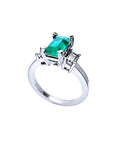 1.09 ct emerald cut Colombian emerald engagement ring in 18K white gold with baguette diamonds.