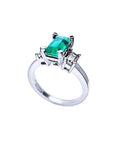 1.09 ct emerald cut Colombian emerald engagement ring in 18K white gold with baguette diamonds.