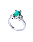 1.09 ct emerald cut Colombian emerald engagement ring in 18K white gold with baguette diamonds.