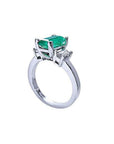 1.09 ct emerald cut Colombian emerald engagement ring with baguette diamonds in 18K white gold.