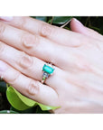 Colombian emerald engagement ring with a 1.09 ct emerald cut medium green stone and baguette diamond accents in 18K white gold.
