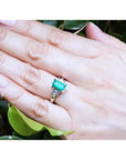 Colombian emerald engagement ring with a 1.09 ct emerald cut medium green stone and baguette diamond accents in 18K white gold.