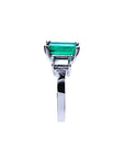 Emerald cut Colombian emerald engagement ring in 18K white gold with baguette diamond accents.
