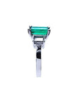 Emerald cut Colombian emerald engagement ring in 18K white gold with baguette diamond accents.