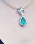 May's birthstone emerald enhancer necklace pear cut medium green hue 6.01 carats encircle by a halo of natural diamonds