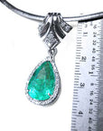 Emerald pendant pear cut medium green hue 6.01 carats encircle by a halo of natural diamonds 18k hite gold