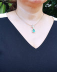 Emerald jewelry for women pendant necklace pear cut medium green hue 6.01 carats encircle by a halo of natural diamonds