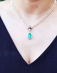 Enhancer Colombian emerald pendant pear cut medium green hue 6.01 carats encircle by a halo of natural diamonds