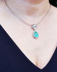 18k white gold emerald enhancer pendant pear cut medium green hue 6.01 carats encircle by a halo of natural diamonds
