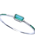 Emerald-cut Colombian emerald bangle bracelet in 14K white gold with natural diamonds.