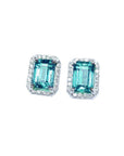 Pair of Colombian emerald stud earrings with halo diamond, front position, full top view.