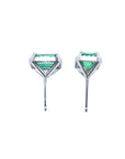 Pair of 1.74 carat emerald-cut natural emerald stud earrings with halo diamonds set in 14K gold.