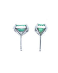 Pair of 1.74 carat emerald-cut natural emerald stud earrings with halo diamonds set in 14K gold.
