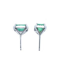 Pair of 1.74 carat emerald-cut natural emerald stud earrings with halo diamonds set in 14K gold.