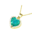 5.04 ct. heart-shaped emerald pendant with diamond halo in 18K yellow gold.