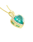 Heart-shaped emerald pendant with diamond halo in 18K yellow gold.