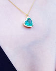 Natural emerald necklaces for sale in USA tilted heart shaped halo natural diamond handcrafted in 18k yellow