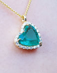 Colombian emerald necklaces for women in USA tilted heart shaped halo natural diamond handcrafted in 18k yellow