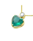 Gold pendant with a heart-shaped emerald and small diamond on top, lef-side profile view.