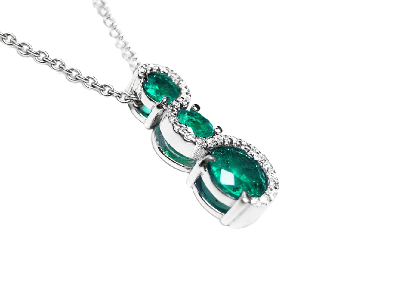 Topside and gallery profile view of emerald journey pendant necklace with diamonds.