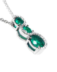 Topside and gallery profile view of emerald journey pendant necklace with diamonds.