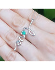 14K white gold "love" script pendant necklace with a round Colombian emerald.