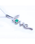 A white gold necklace with a script love pendant featuring an emerald stone on a white background.