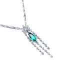 Marquise cut Colombian emerald necklace in 14K white gold with diamond links and floral accents.