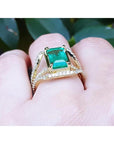 18K yellow gold engagement ring with a 2.86 ct emerald and three rows of natural diamonds.