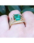 18K yellow gold engagement ring with a 2.86 ct emerald and three rows of natural diamonds.