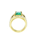 18K yellow gold engagement ring with a 2.86 ct emerald and three rows of diamonds.