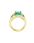 18K yellow gold engagement ring with a 2.86 ct emerald and three rows of diamonds.