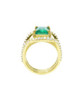 18K yellow gold engagement ring with a 2.86 ct emerald and three rows of diamonds.