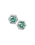 Pair of round emerald stud earrings in 14K white gold with a hexagonal diamond halo.