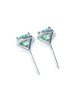 Pair of round cut emerald stud earrings in 14K white gold with push back closures.