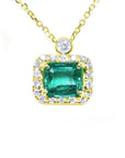 Colombian emerald necklace east west orientation encircled in a halo of natural diamonds, crafted in 14k yellow gold