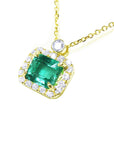 Natural emerald necklace east west orientation encircled in a halo of natural diamonds, crafted in 14k yellow gold