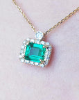 Natural diamond emerald necklace east west orientation encircled in a halo of natural diamonds, crafted in 14k yellow gold