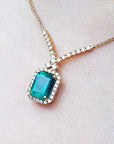 Emerald-cut Emerald necklaces Muzo Colombia natural deep green bluish color, encircled by a halo diamond high quality