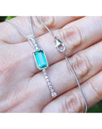 Women's 14K white gold necklace with a rectangular Colombian emerald and diamond accents.