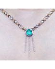 14K white and yellow gold Kisses and Hugs necklace with a square emerald pendant and diamond dangles.