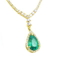 Front view gold necklace with a green natural emerald teardrop pendant on a white background